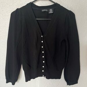 Black cardigan with pearly white buttons.